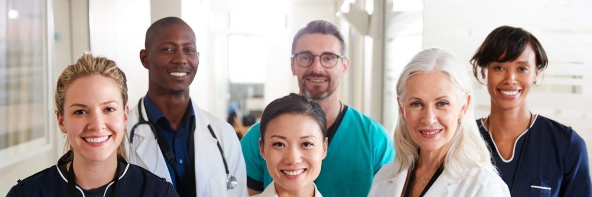 Portrait Of Medical Team Standing In Hospital Corridor